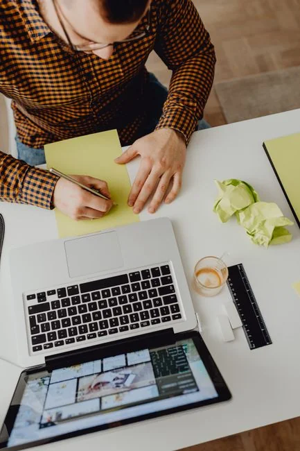 A person using a laptop to browse stock photo websites. Freelancing work in a cozy setting.